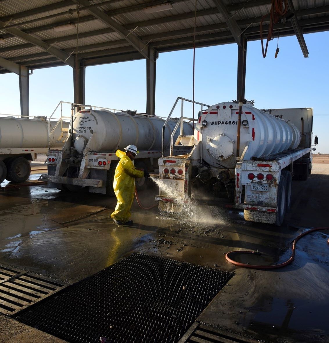 A milestone worker cleaning the truck bays