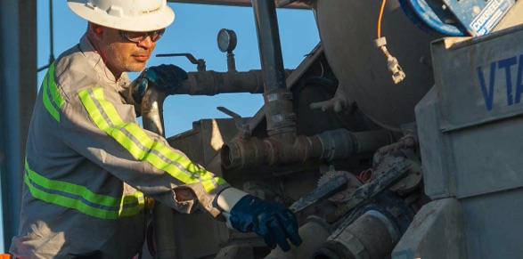 A Milestone worker adjust injection pipes at facility.