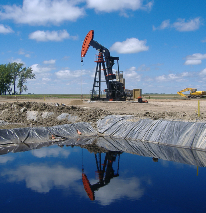 A pumpjack pictured above a waste pit