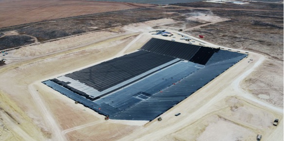 An overview of a landfill under construction in a desert.